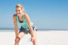 Femme qui fait de l'exercice à la plage