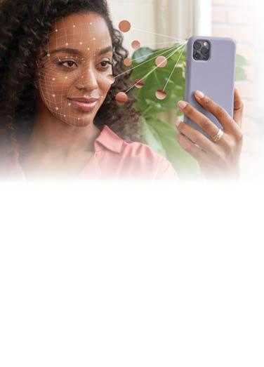 Women holding phone towards face to use Neutrogena Skin360 Application